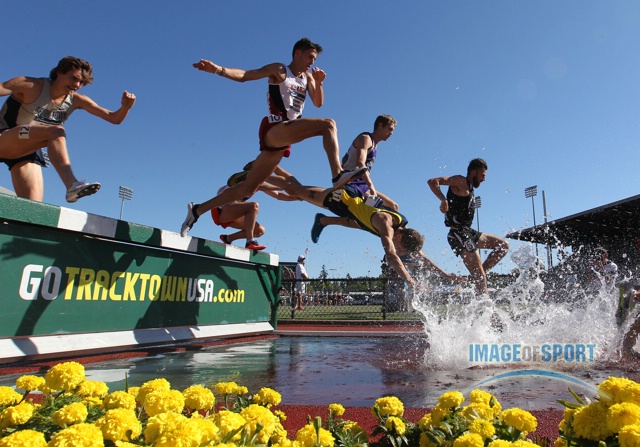 Jun 12, 2015; Eugene, OR, USA; Mason Ferlic of Michigan (17) falls in the water jump in the steeplechase in the 2015 NCAA Track & Field Championships at Hayward Field.