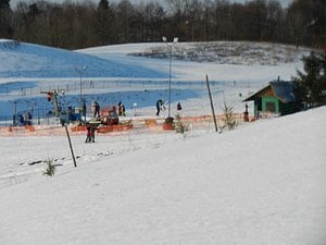 People skiing next to the hill