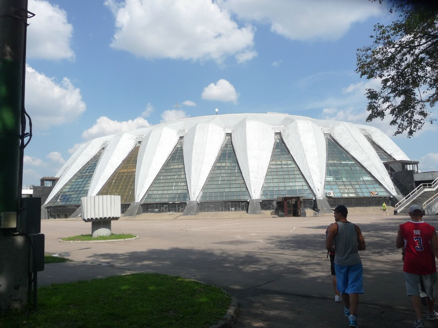 This is some sort of stadium but it is being used as the place you pick up your media pass