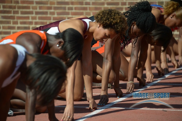 Olivia Ekpone of Texas A&M (center) in the starting blocks a womens 100m heat