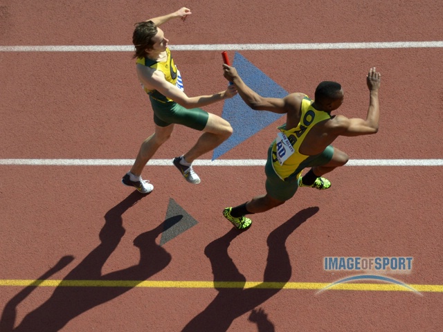 Arthur Delaney of Oregon takes the handoff from Elijah Greer in a 4 x 400m relay heat