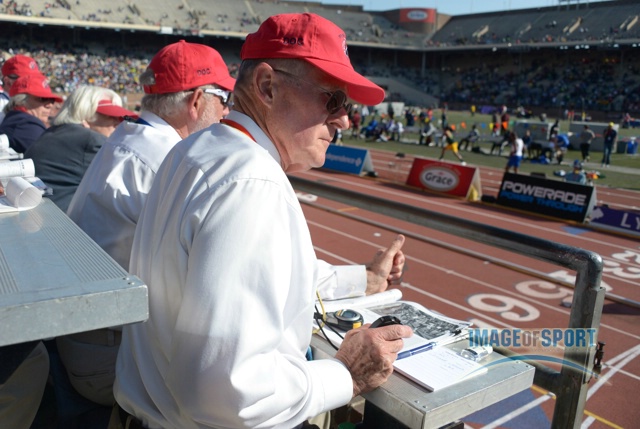 Timers take splits on a stopwatch in the 119th Penn Relays at Franklin Field.