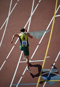 Kevin Anding of Oregon casts a shadow in a 4 x 400m relay heat