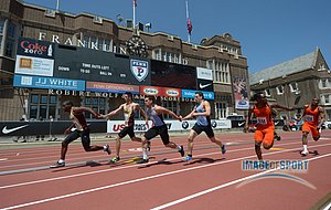 General view of the handoff in a college mens 4 x 100m relay heat