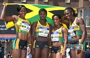 Members of the Jamaica womens 4 x 400m relay pose with a flag after winning the USA vs The World race in 42.42. From left: Sherone Simpson and Anneisha McLaughlin and Shelly-Ann Fraser-Price and Kerron Stewart.