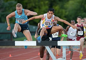 Matt Hughes (CAN), left, would defeat Jose Pena (VEN) to win the steeplechase, 8:21.34 to 8:22.56