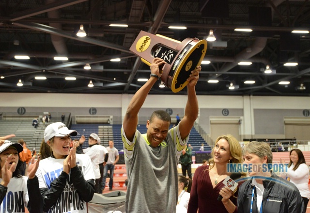 Mar 15, 2014; Albuquerque, NM, USA; Oregon Ducks coach Robert Johnson hoists the championship trophy after the Ducks won the womens team title in the 2014 NCAA Indoor Championships at Albuquerque Convention Center.