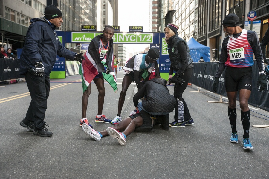 Mo Farah Out on the Ground with Geoffrey Mutai, Mary Wittenberg, and Meb Keflezighi