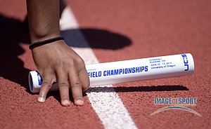 Robyn Reynolds of Florida holds a baton in the starting blocks of the womens 4 x 100m relay