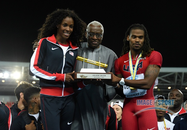 Lamine Diack (center) presents United States captains DeeDee Trotter (left) and David Verburg with the Golden Baton