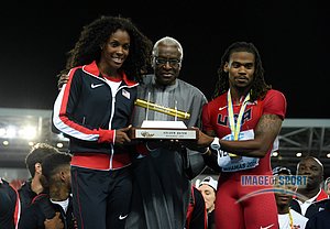 Lamine Diack (center) presents United States captains DeeDee Trotter (left) and David Verburg with the Golden Baton