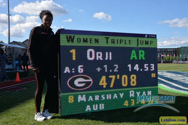 Kenturah Orji of Georgia poses with scoreboard after winning the women's triple jump in an American record 47-8 (14.53m)