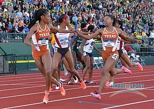 Courtney Okolo takes the handoff from Zola Golden on the anchor of the Texas women's 4 x 400m relay that won in 3:27.64
