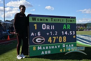Kenturah Orji of Georgia poses with scoreboard after winning the women's triple jump in an American record 47-8 (14.53m)