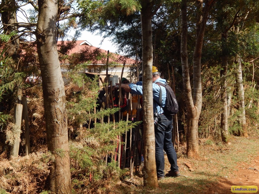 School kids on other side of fence from training camp