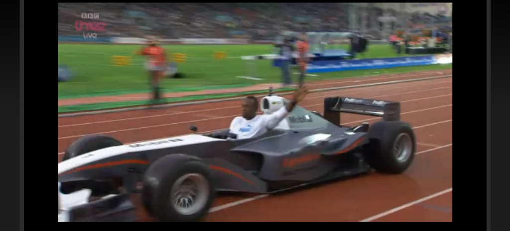 WTF? Pre-race Bolt zoomed around the track in a race car with ExxonMobil all over it