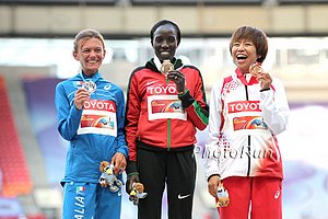 Edna Kiplagat atop the podium at 2013 Worlds