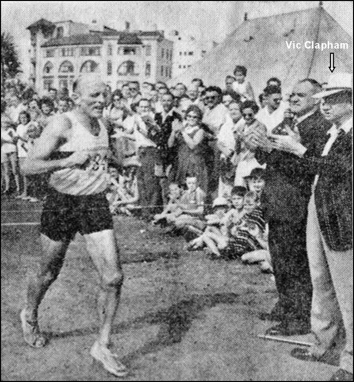  George Claassen crosses the finish line of the Comrades Marathon in 1961, watched by Comrades founder Vic Clapham. (Photo courtesy of the Comrades Marathon Association)