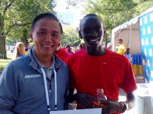 Coach James Li of the University of Arizona and Stephen Sambu after Sambu won the 2014 B.A.A. 10-K in a world-leading 27:25 earlier this year (Photo by Karen Locke)