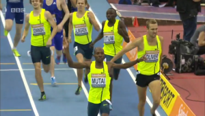 Jeremiah Mutai celebrates as the top guys all share the same singlet