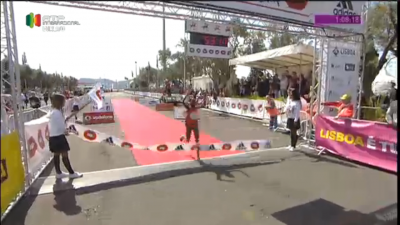 Chelimo crosses the line (the clock was showing the men's time)