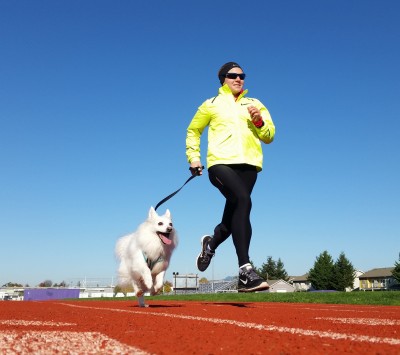 Johnson running with one of her favorite training partners: her American Eskimo, Luna (Photo courtesy Nick Johnson)