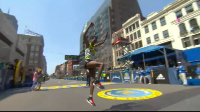 Berhanu celebrates with a hop, skip and jump after the finish line.