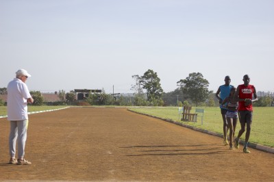 Canova looks on as Kiplagat begins her workout at Moi University