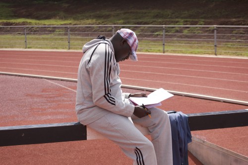 Coach John Litei reviewing the workout