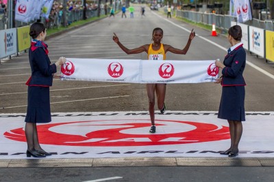 Brigid Kosgei celebrates her 2016 Honolulu Marathon victory, Photo By Eugene Tanner/Honolulu Marathon