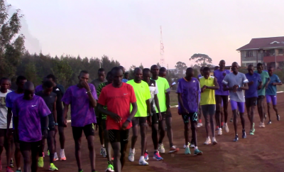 Kipchoge (red) and crew at track