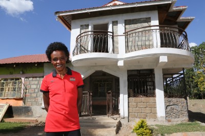 Sumgong In Front of the House She is Building (by Jean-Pierre Durand for the IAAF)