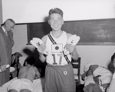 Tanaka and the split-toe shoes he used in the 1951 Boston Marathon. Leslie Jones/Boston Public Library.