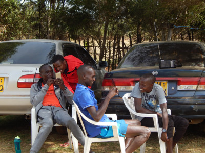 Kipchoge and his training mates relax after a morning workout. Photo by Weldon Johnson.