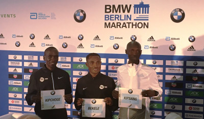 Eliud Kipchoge, Kenenisa Bekele and Wilson Kipsang pose for photographers before the 2017 BMW Berlin Marathon (photo by David Monti for Race Results Weekly)