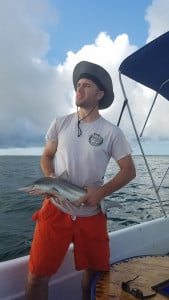 You champion Jason holding a sharpnose shark, a species used in his biology research