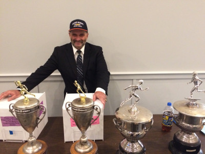 Mahon and his trophies (the boys' and girls' Mahon Cups are on the right)