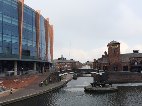 The arena is on the left, the pub on the right across the bridge