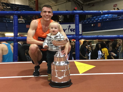 Chris O'Hare with son Ronan after winning the NYRR Wanamaker Mile at the 2018 NYRR Millrose Games (photo by Jane Monti for Race Results Weekly)