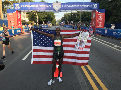 Lagat celebrating his 10k win at Peacthree this year. Photo by USATF; used with permission