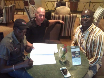 Manangoi signing his contract with Nike's Robert Lotwis & Ouma