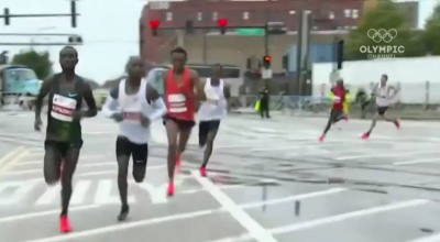 Mo Farah is the guy in red in the back going around the turn